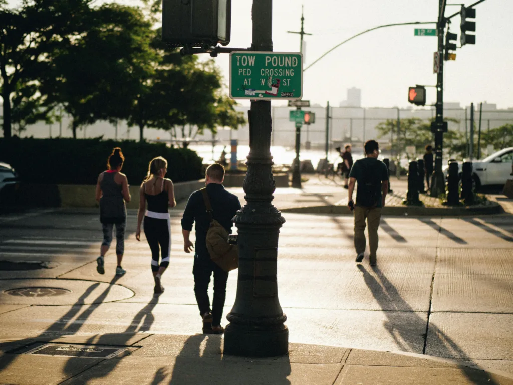 Pedestrians walking at a busy Texas intersection where pedestrian accidents often occur