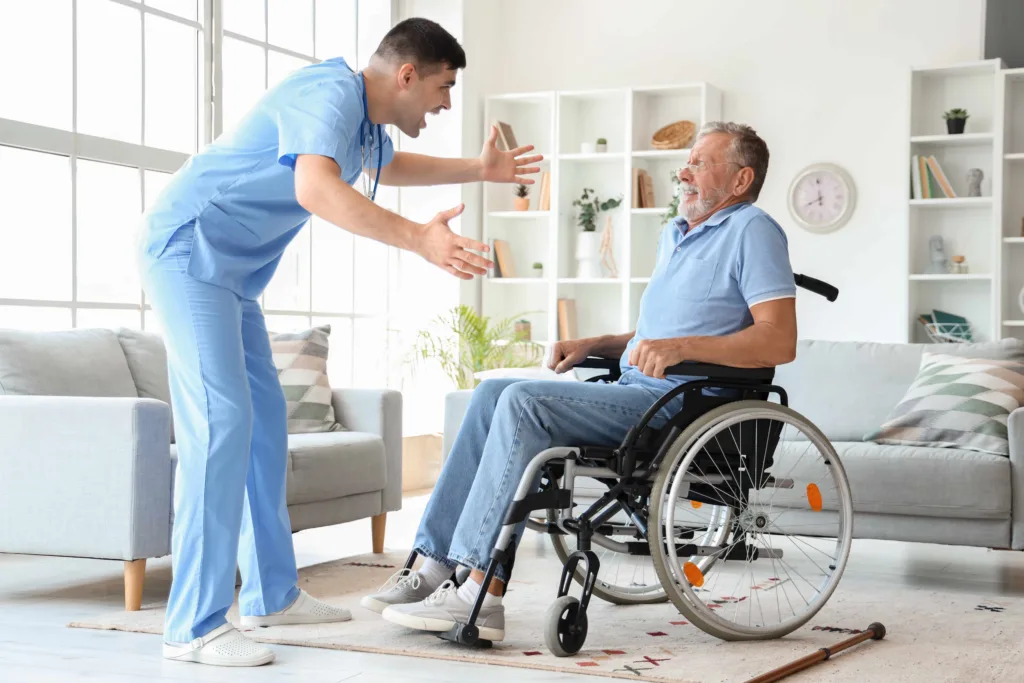 Caregiver assisting elderly man in wheelchair at home, highlighting senior care, mobility support, and in-home healthcare services.
