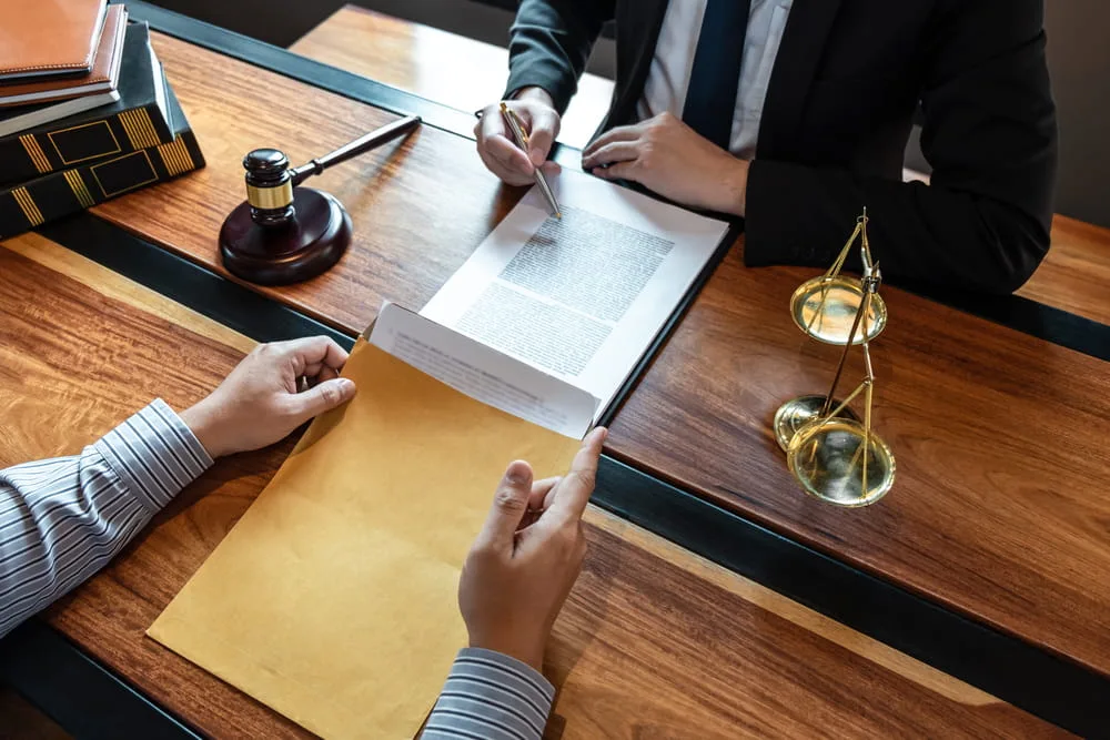 Attorney reviewing legal documents with a client regarding a Texas dog bite claim.