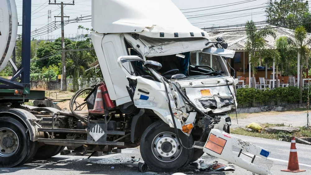 Severely damaged commercial truck following a roadway collision.