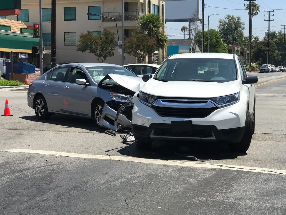 Insurance investigator assessing vehicle damage to determine fault in a Texas accident claim