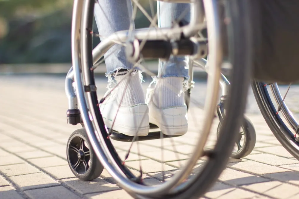 Individual using a wheelchair after sustaining a catastrophic injury in Texas