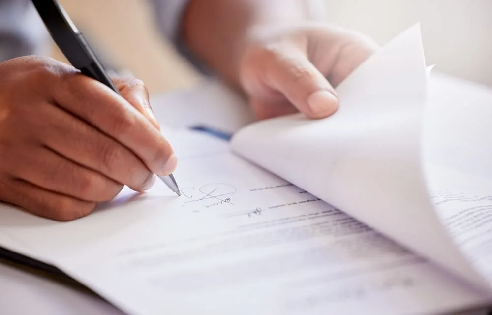 Injured accident victim reviewing and signing settlement documents after a Texas injury claim