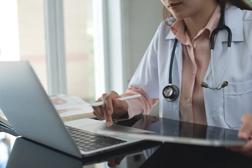 Physician reviewing medical records to assess the severity of a spinal cord injury