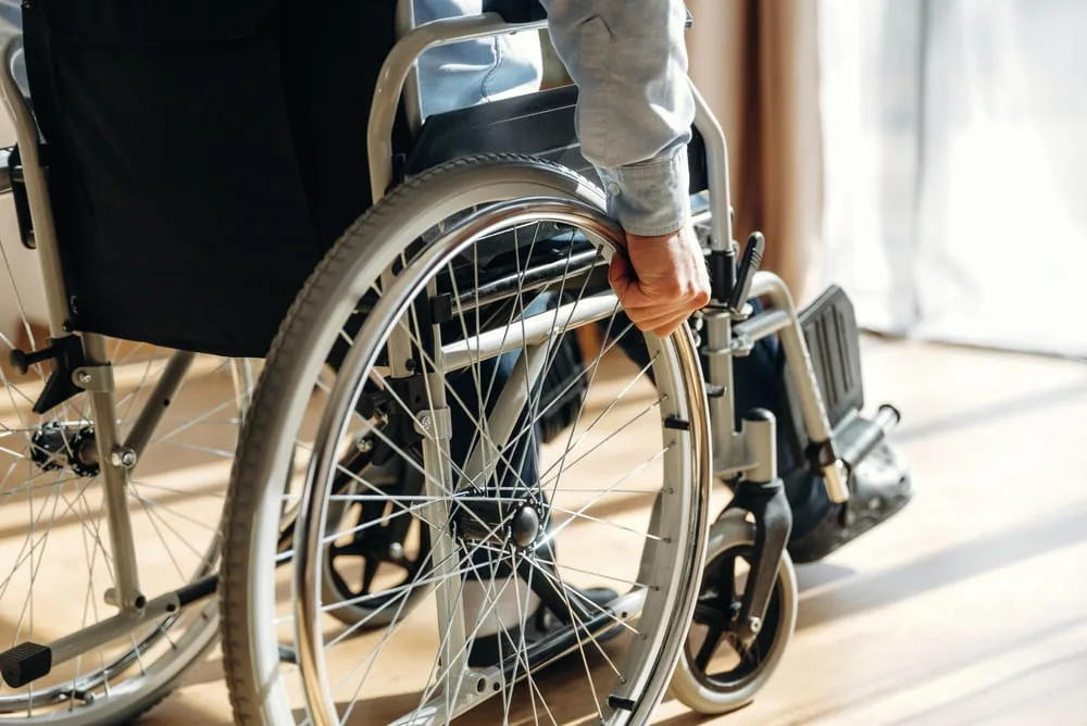 Individual using a wheelchair after sustaining a life-changing spinal cord injury