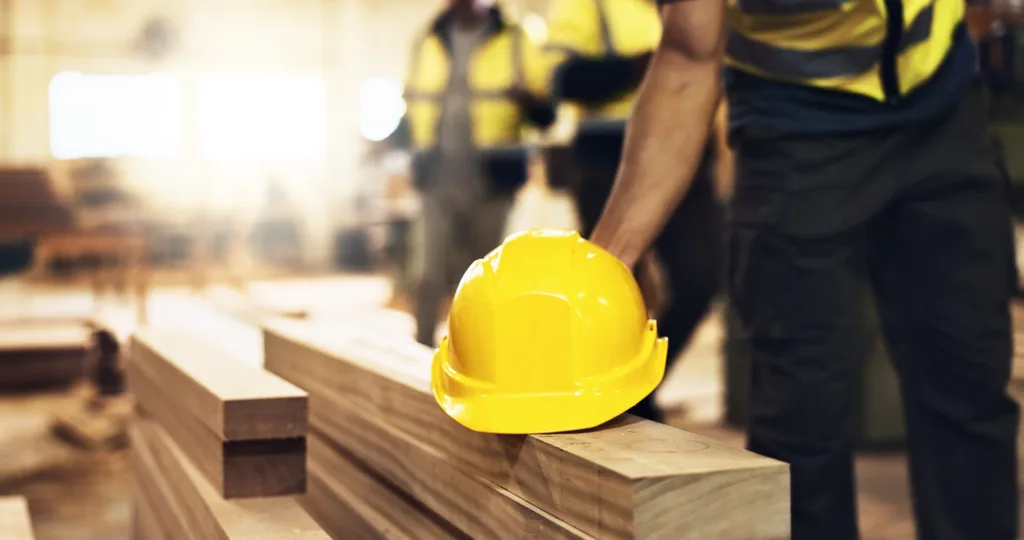 Construction worker reaching for a hard hat at a Texas job site