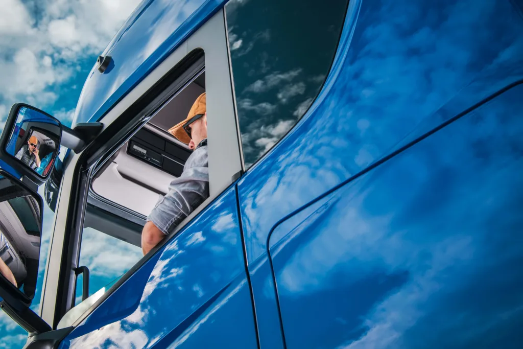 Commercial truck driver in the cab of a semi during a long haul